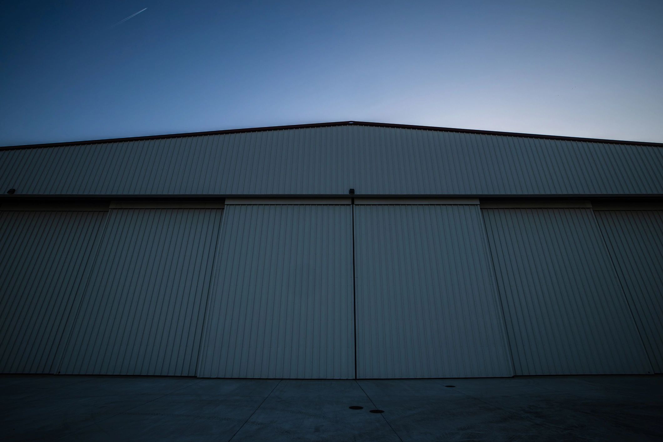 Large commercial facility exterior at sunset
