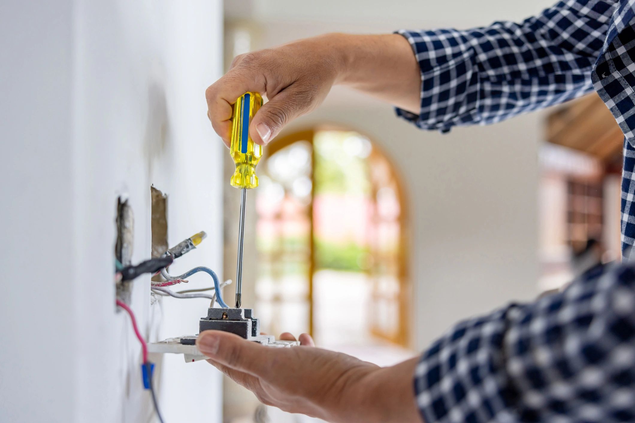 Electrician working on electrical wiring and outlet installation
